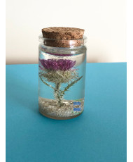 Resin flask containing a real dried thistle