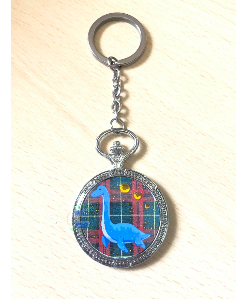 Keychain round gousset Nessie green/red tartan